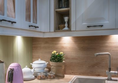 Kitchen utensils on a wooden table top in a beautiful modern kit